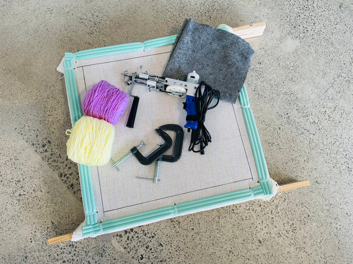 Tufting frame, gun, yarn and tools arranged as a practical home setup