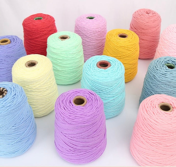 Assorted bright tufting yarn rolls showing a wide range of colours
