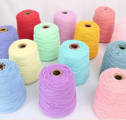 Assorted colorful yarn rolls on a white background